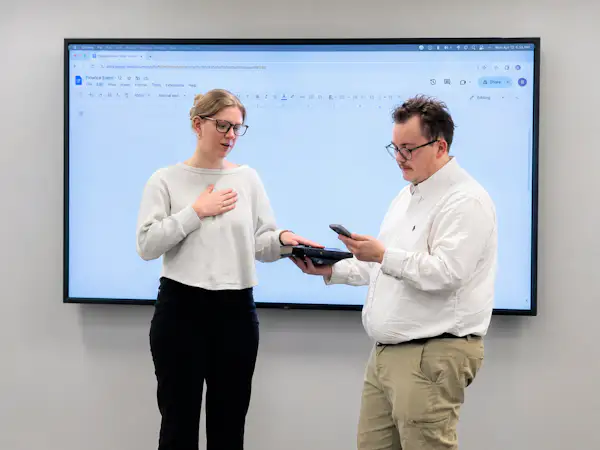 A college student puts her hand on the Bible as she is sworn into a student government role