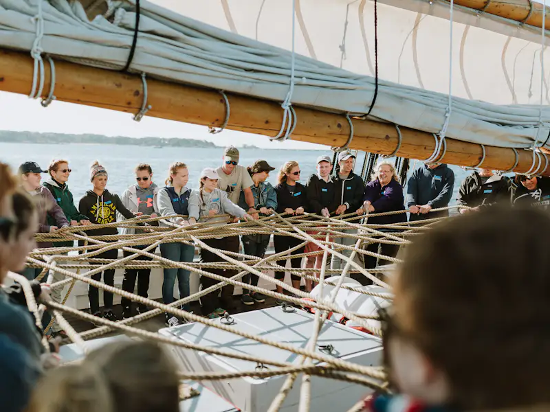 Honors students at Gordon College participate in a team building exercise on a boat