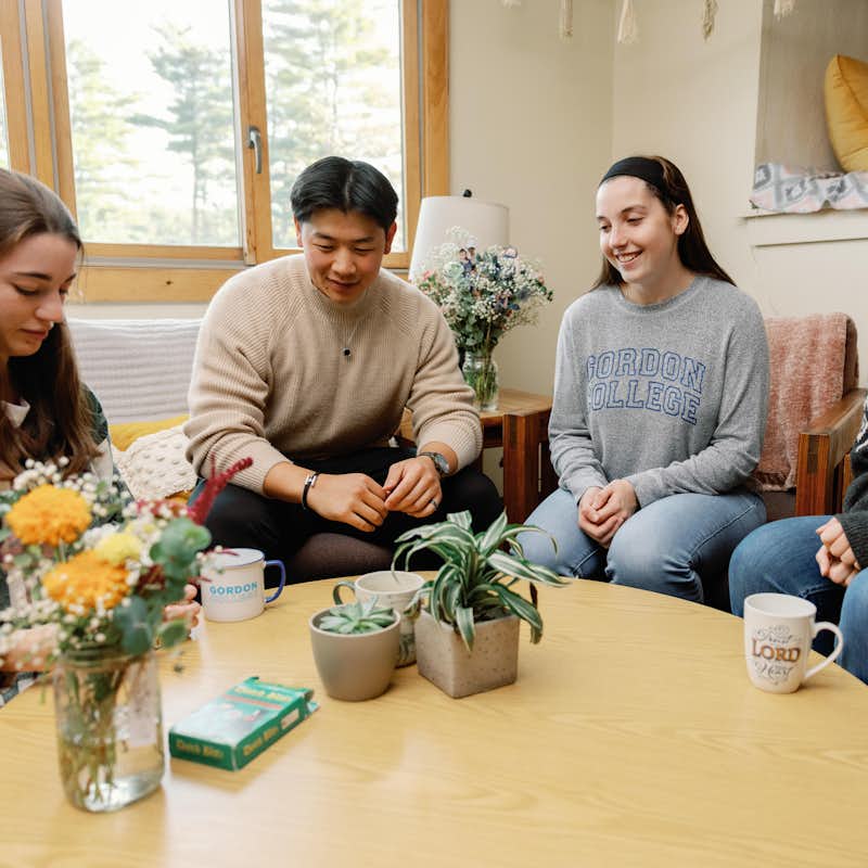 Students playing a card game in a residence hall.