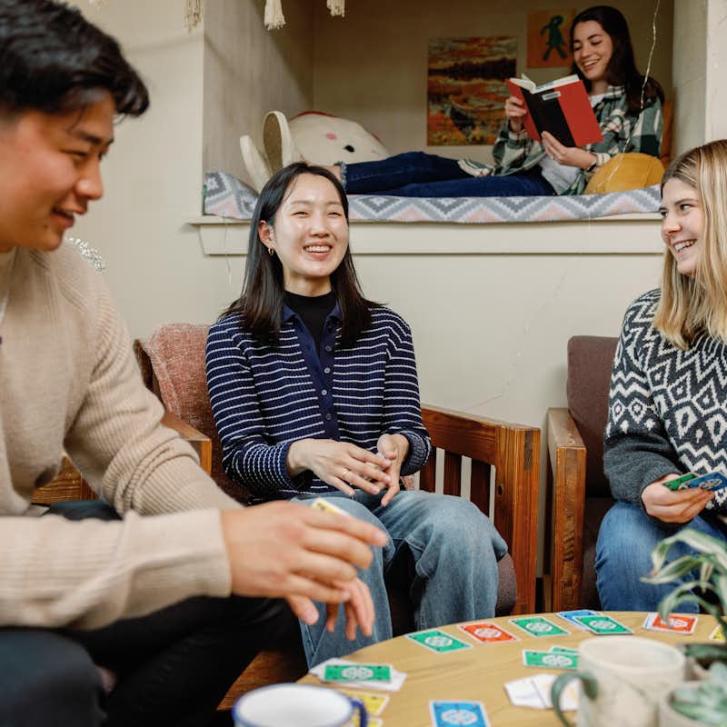 Four students play a game in campus apartment