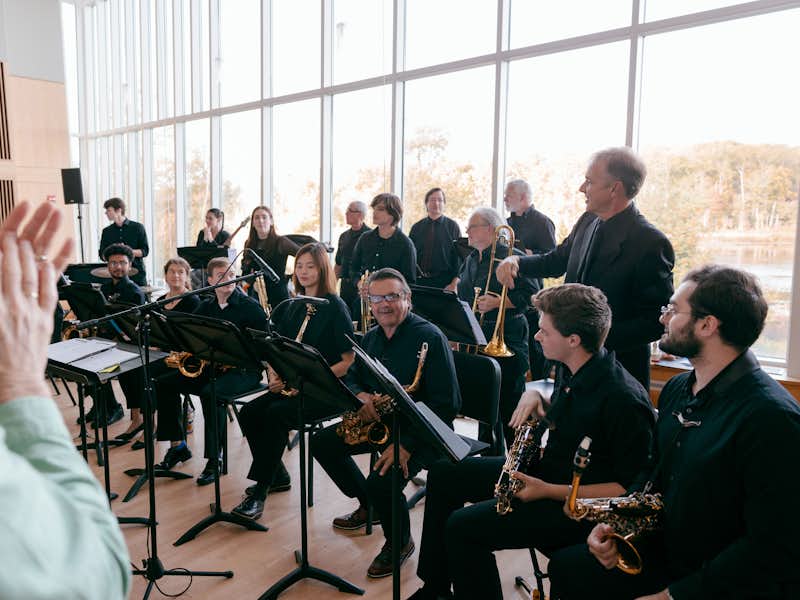 An audience claps for a group of musicians who have finished performing.