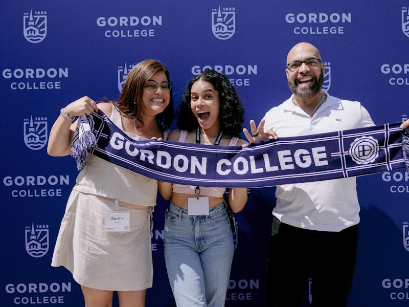 A transfer student is welcomed at orientation with her parents.