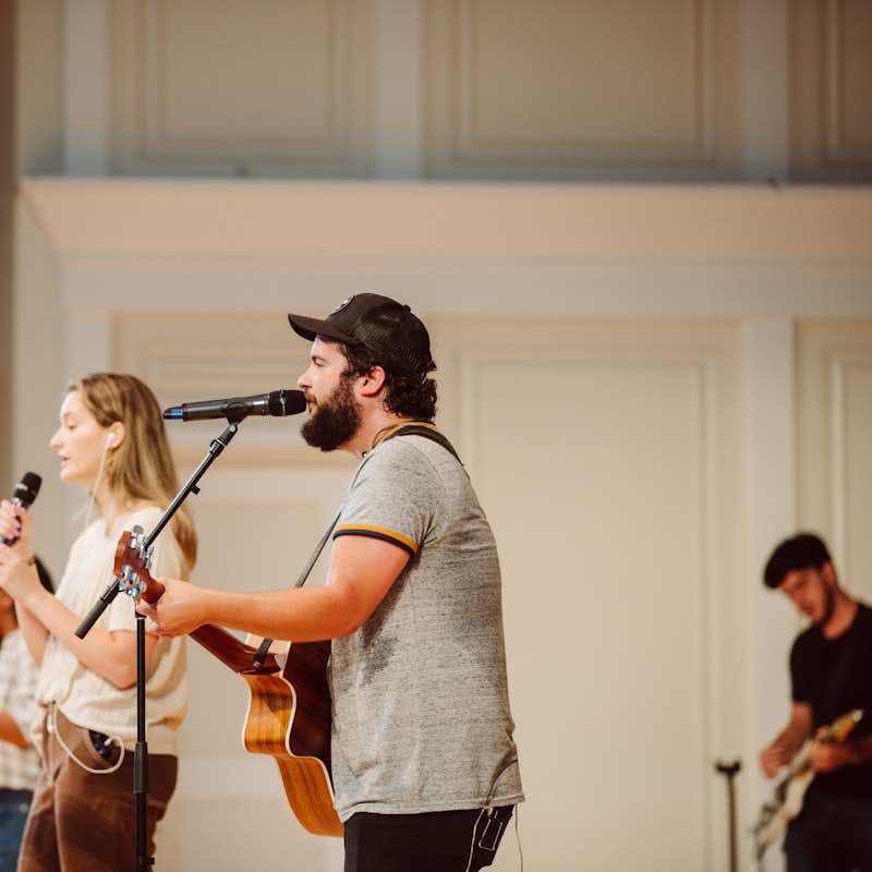 Students sing on stage at a chapel worship service