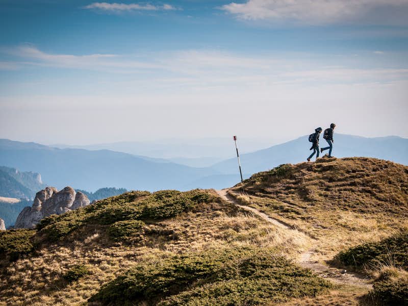 Two hikers walk on a mountain in Washington