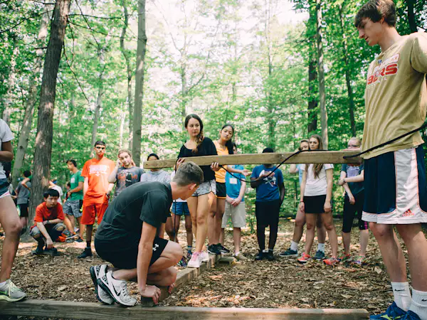 Students work together to complete a team building exercise