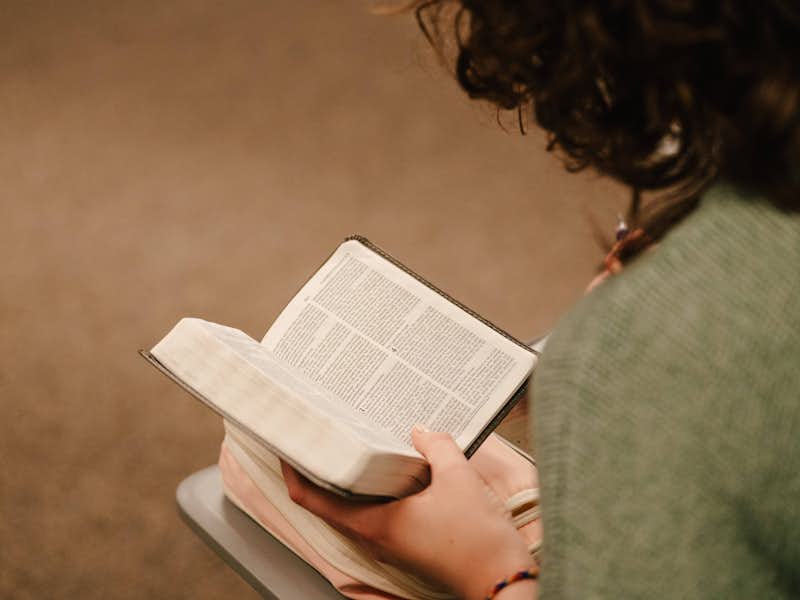 Close up shot of a Bible in student's hand