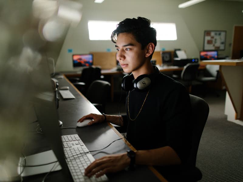 Student working on computer in video editing lab