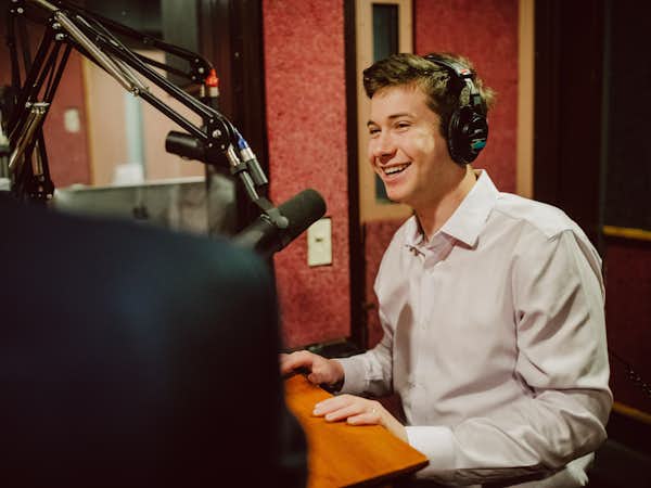 Student recording a podcast in studio