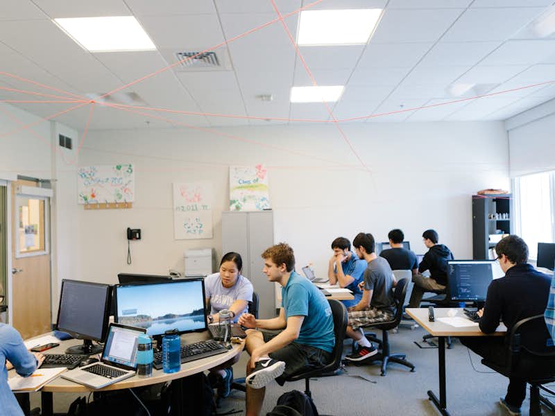 Computer science students in class working on group projects