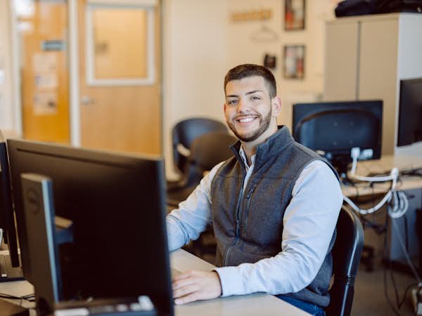 Computer Science student works at his desk