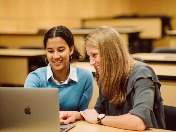 A student works with a professor on course work
