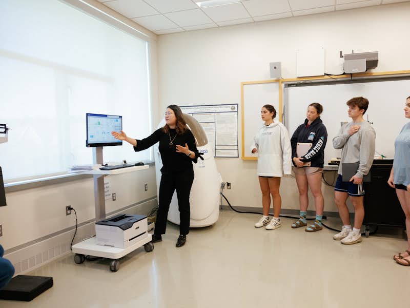 Professor illustrates use of health equipment to students in lab