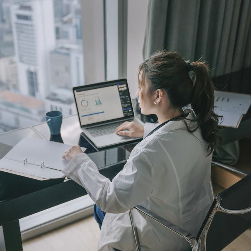 A Public Health Graduate student works at a desk in the city.