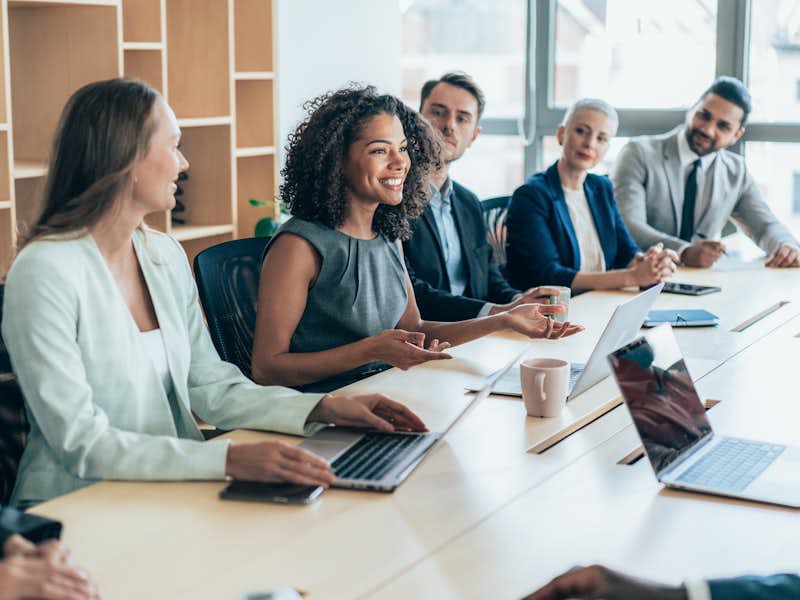 Professionals sit at a conference table