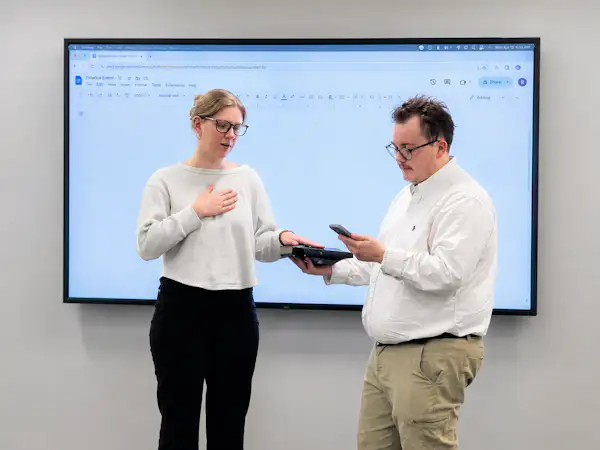 A college student puts her hand on the Bible as she is sworn into a student government role