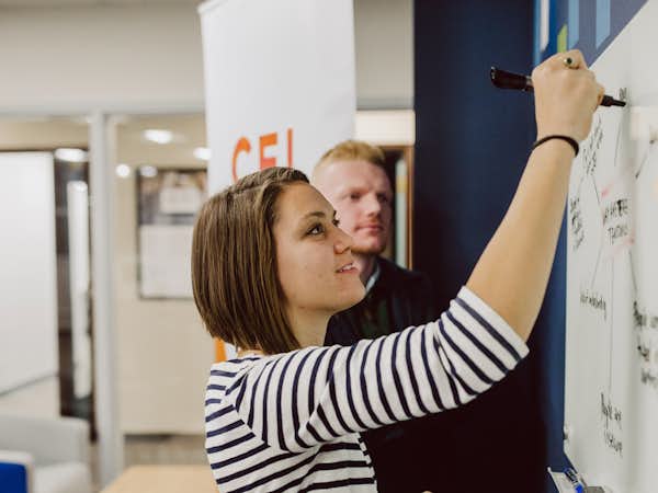 A student writes on a white board