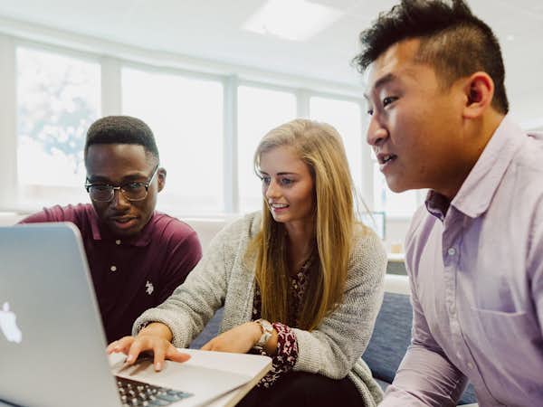 Students look at a computer together