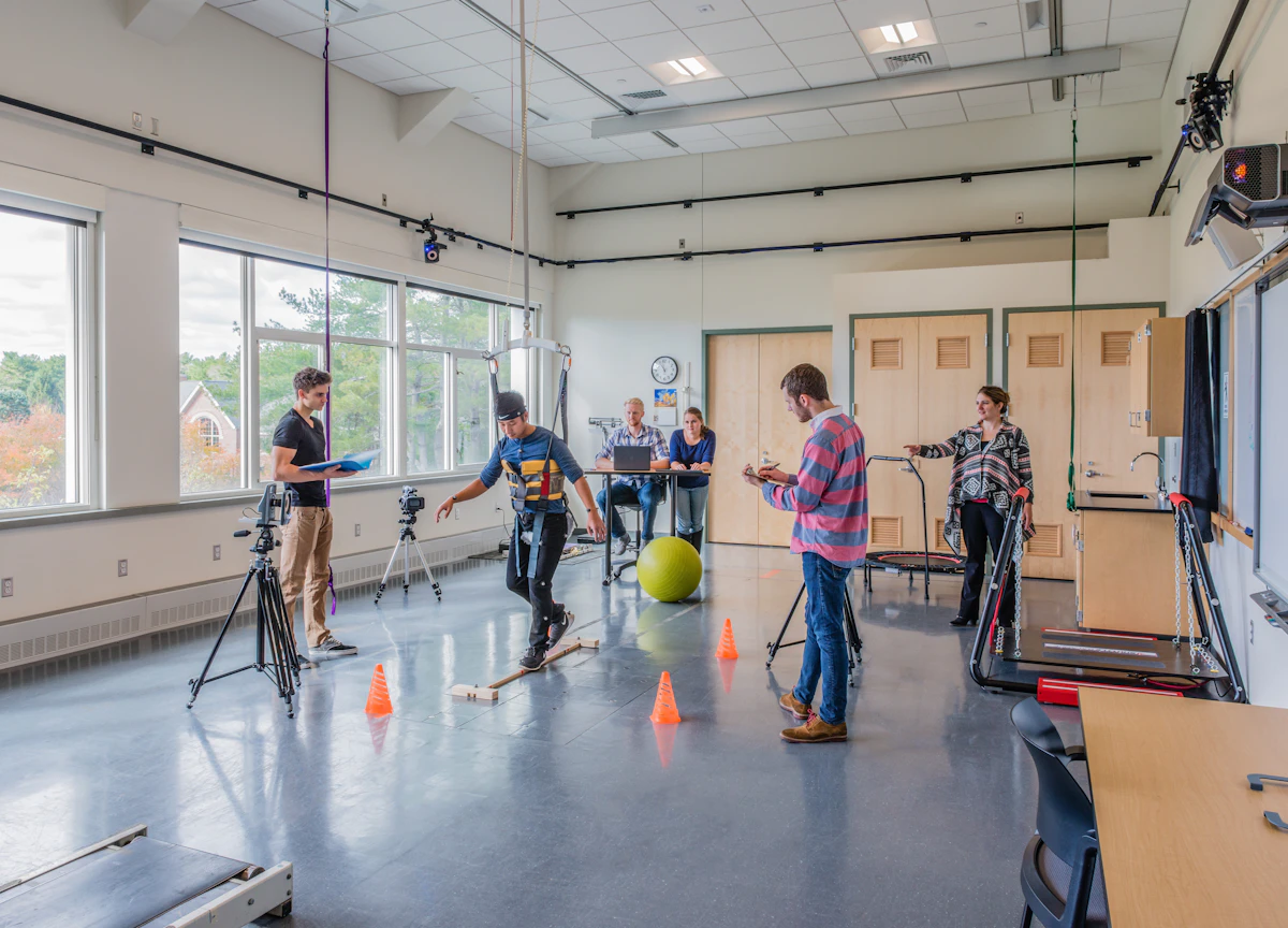 College students work in a kinesiology lap as they learn how to use a tool with their professor.