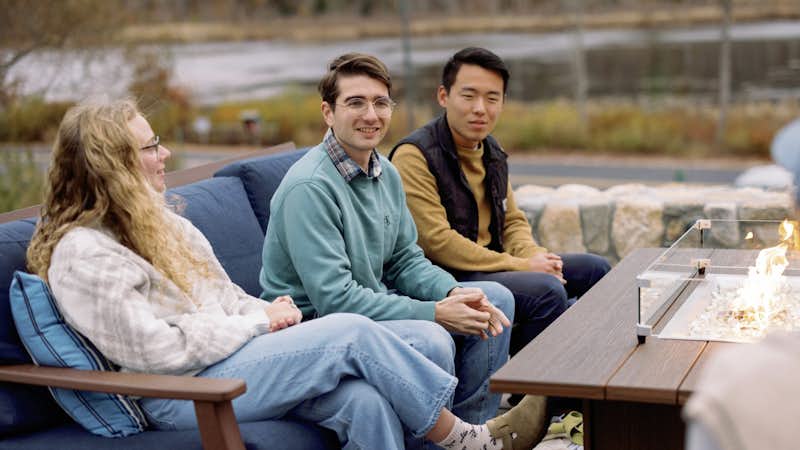 Students sitting on a couch on the Frost patio expressing gratitude.